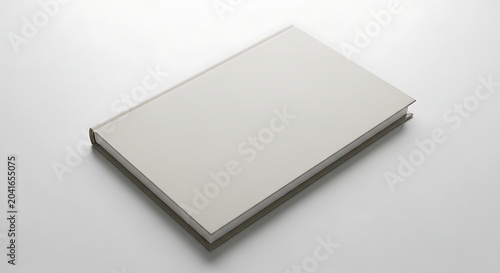 Closed Blank White Hardcover Book Resting on Minimal Studio Surface