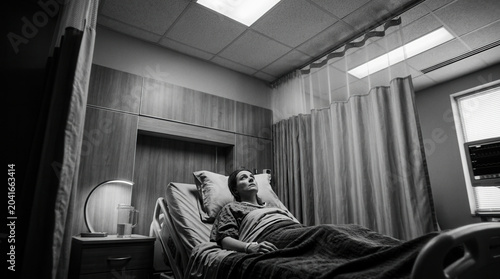 Patient Recovers After A Medical Procedure Lying In The Hospital Bed Monochrome Photo