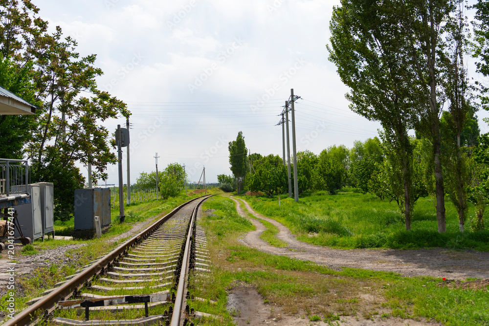 Fototapeta premium Railway Track Through Green Countryside Landscape