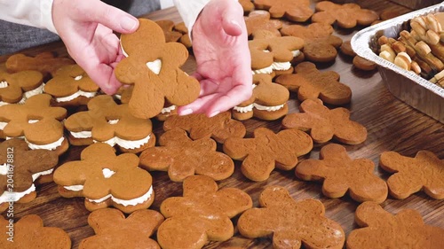 Making Festive Gingerbread Sandwiches on Rustic Wooden Table