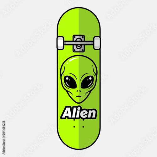 Green skateboard with alien face design.