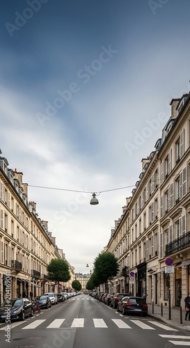 Narrow European Street Lined with Historic Buildings Under Cloudy Sky