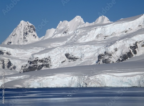 spectacular Antarctica  mountain peaks and ice floes  on a sunny summer day in the neumayer channel in the palmer archipelago in  northern antarctica
