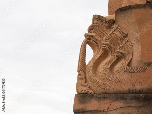 Naga Khmer sculpture about 1,500 years ago on castle roof. stone, god, folk, Hindu, tourism, statue , design, cultural, artifact, education, religion, history, temple, travel, old, craft, sky, myth