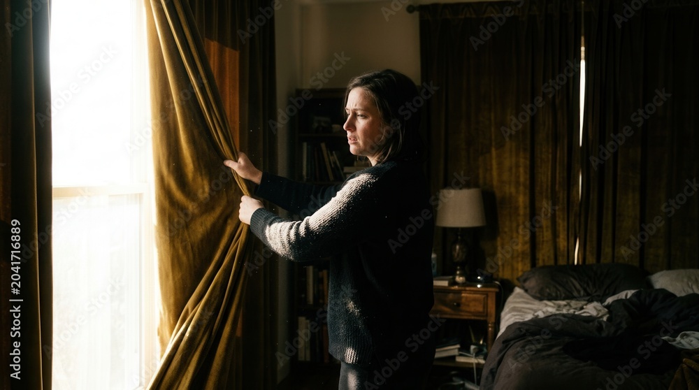 Fototapeta premium Woman Opening Curtains Letting Sunlight Into Her Bedroom, Golden Morning, Indoor Scene