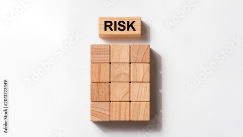 Wooden blocks forming a grid with one block showing 'RISK'