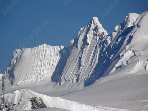  close up of spectacular Antarctica  mountain peaks  on a sunny summer day in the neumayer channel in the palmer archipelago in  northern antarctica