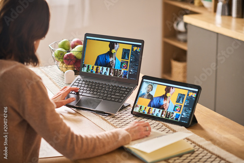 Fotografía Middle aged Caucasian woman learning photo editing online on laptop and tablet at home, building digital skills