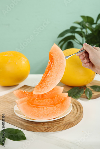 Fresh Honeydew Melon Slices Being Cut on Wooden Board - Healthy Sweet Fruit Preparation