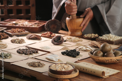 Photos Chinese Medicine Practitioner Formulating Traditional Herbal Remedies with Ancie