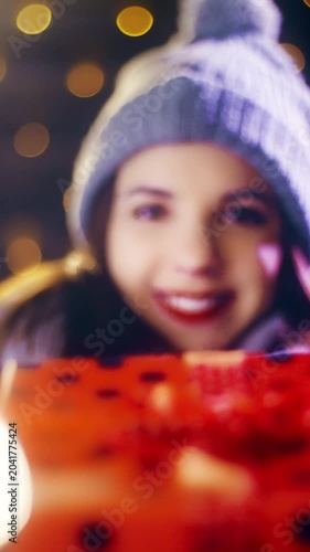 Beautiful girlfriend gives Christmas present gift box to the camera POV