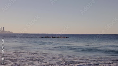 a long shot of a surf ski race, on a beautiful winter's afternoon, at burleigh heads on queensland's gold coast of australia