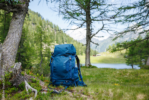 Hiking backpack in forest in Alp mountains. Travel and trekking outdoor equipment