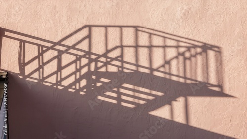 Minimalist Architectural Composition of Graphic Shadows Cast by Stairs on a Beige Wall