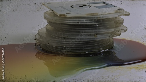 Stack of Vintage Melting or Damaged Floppy Disks on a Shiny Surface