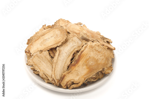 Dried Angelica Root Herbal Medicine on White Plate - Traditional Chinese Herb for Natural Health and Wellness