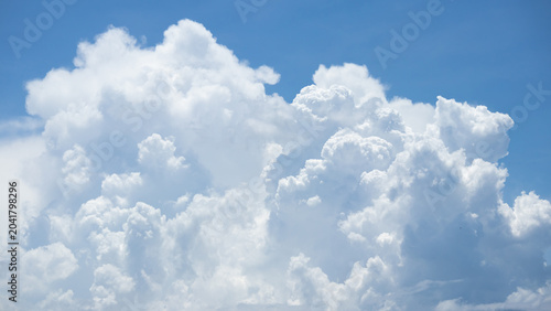Photos fluffy white clouds building up in the light blue sky