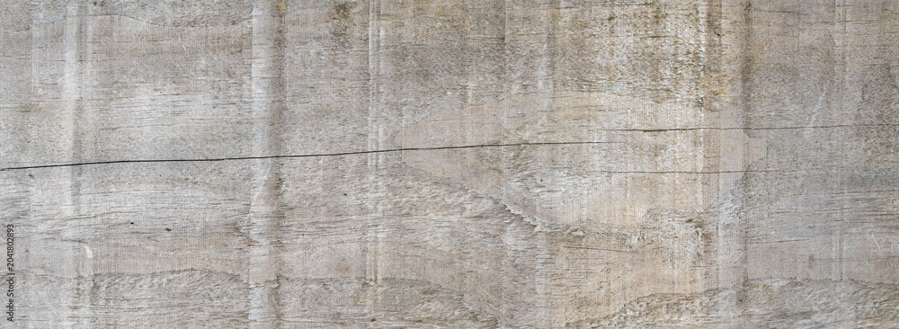 Fototapeta premium Weathered grey wooden board texture with natural grain and cracks as panoramic background