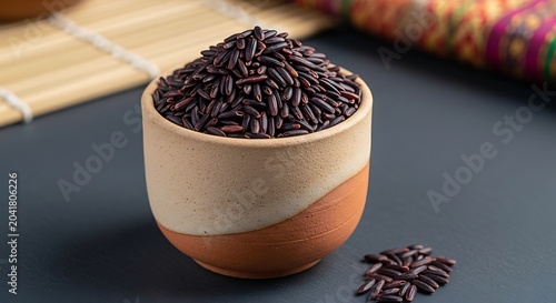 Dark Purple Rice Piled in Rustic Ceramic Bowl on Dark Table