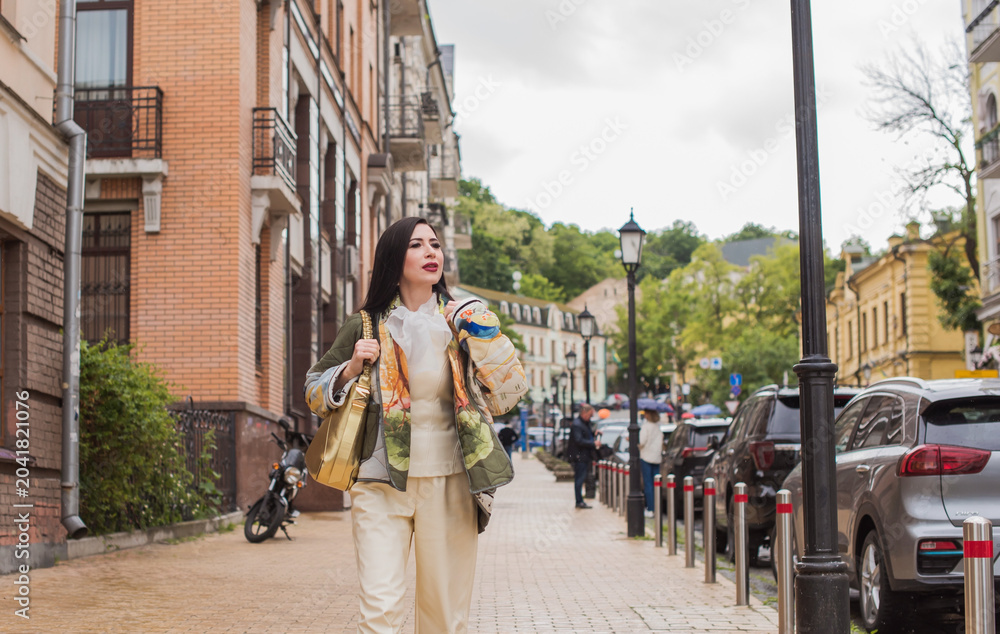 Naklejka premium Happy middle aged woman exploring European city architecture during vacation, elegant mature female tourist walking on town street, solo travel and financial freedom concept