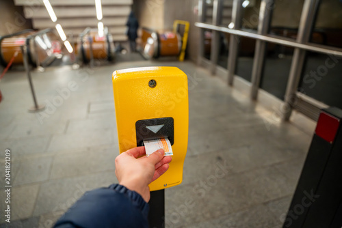 Photography Passenger validating public transport ticket in Prague metro station