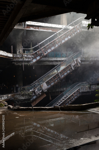 Suspended in a state of timeless abandonment, this decaying post-industrial ruin is defined by a stagnant silence that lingers heavily in the misty air. Framed by weathered concrete and rusting struct