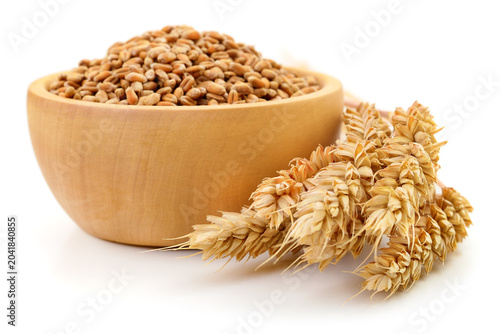 Wheat Grains in Wooden Bowl with Spikes Isolated on White Background