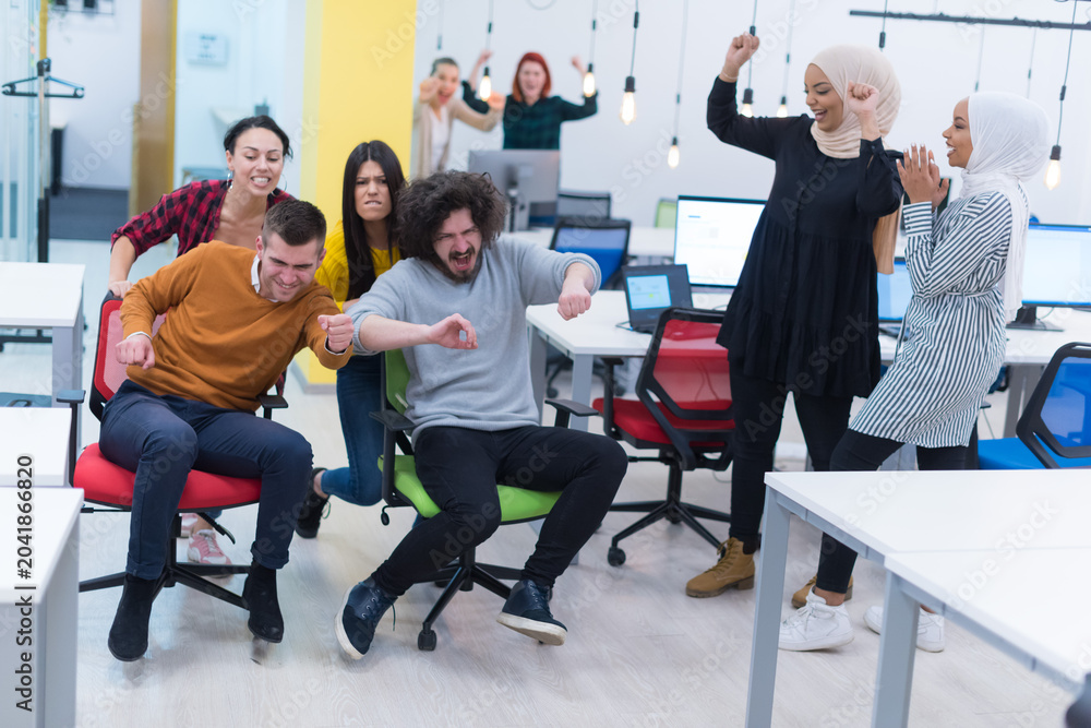 Fototapeta premium Coworkers Having Fun With Office Chair Races