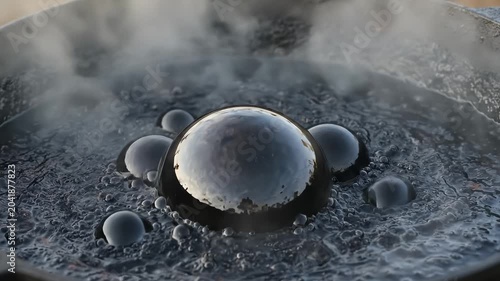 Large Dark Bubbles Forming on Boiling Thick Black Liquid