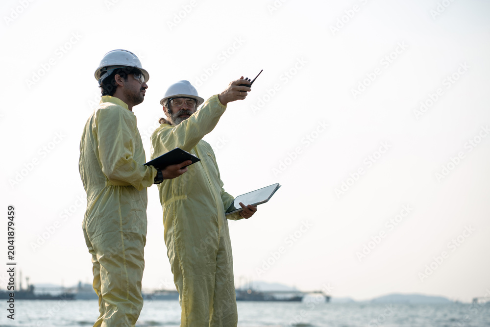 Naklejka premium Team analyzing environmental research on industrial wastewater treatment.