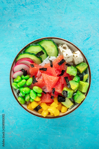 Vegan poke bowl with grapefruit, avocado, mango, edamame, radish