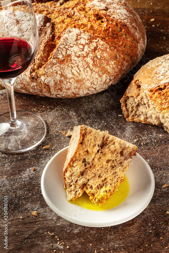 Close-up of a rustic, torn piece of homemade artisan sourdough bread