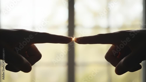 Two Fingers Touching Creating a Bright Electrical Spark Effect