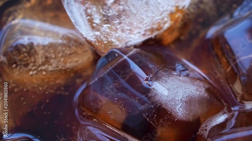 Macro Close Up of cola bubbles and ice cubes background