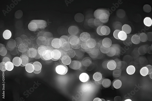 Soft, blurred circles of light create a dreamy, abstract nighttime cityscape