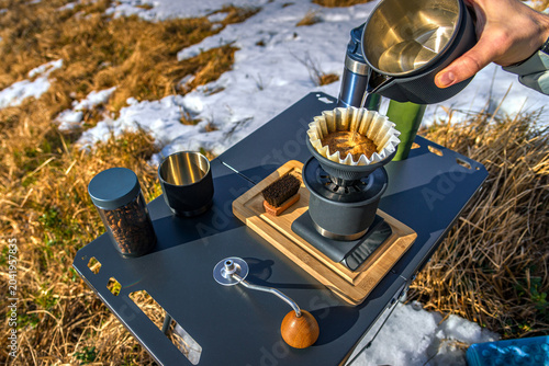 Schilderij op canvas Pour over coffee brewing in mountains with portable outdoor specialty coffee set