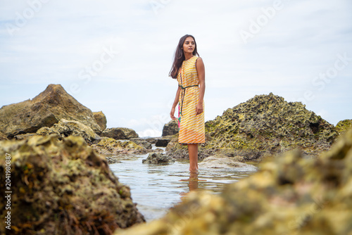 Young Woman Standing Among Coastal Rocks in Indonesia