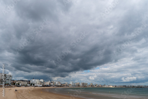 View of the beach at Les Sables d'Olonne under a threatening sky, Vendée, France