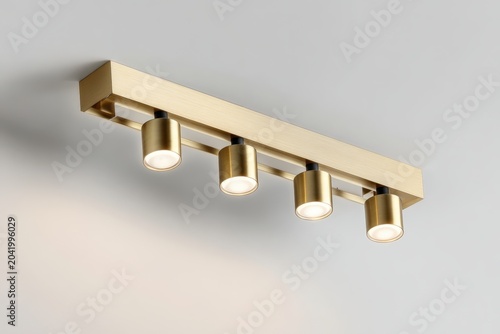 Modern ceiling with sleek golden metal track lights. Spot lighting led system. Closeup Room spotlights for interior design, commercial illumination. Minimalist white surface. Contemporary ambiance