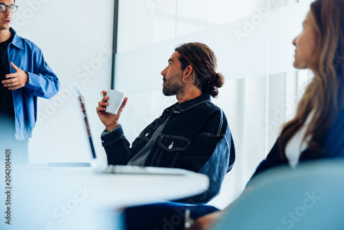 Colleagues engaged in focused discussion during office meeting