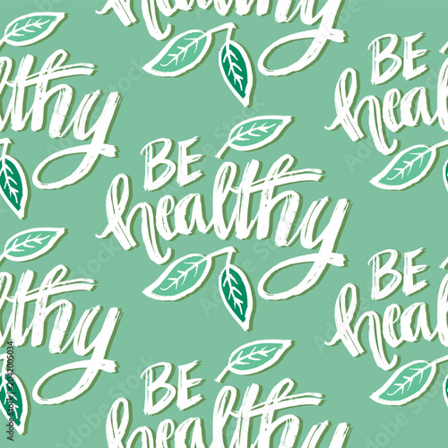 Be healthy. Hand drawn lettering seamless pattern on green background. Vector illustration.
