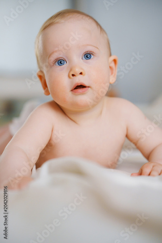 Close up portrait of a charming infant looking up in wonder