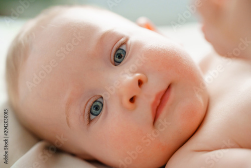 Close-up Frontal Portrait of Happy Curious Infant