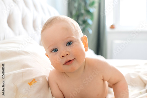 Curious Baby Learning to Crawl on Bed