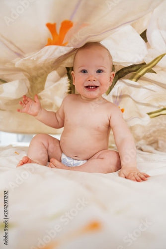 Cute Baby Sitting Under Floral Fabric Canopy