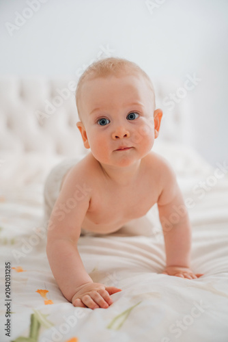Curious Baby Learning to Crawl on Bed