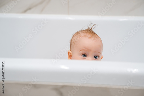 Close-up of Baby Eyes Peeking Over Bathtub Edge