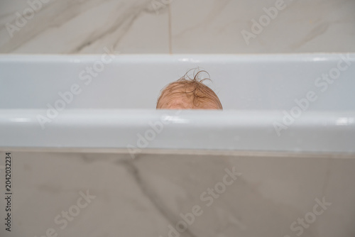 Playful Baby Playing Peek-a-Boo in the Bathtub