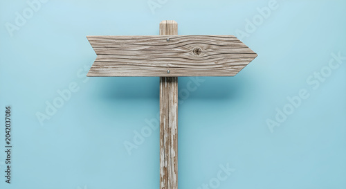 Rustic wooden arrow sign blank template on light blue background