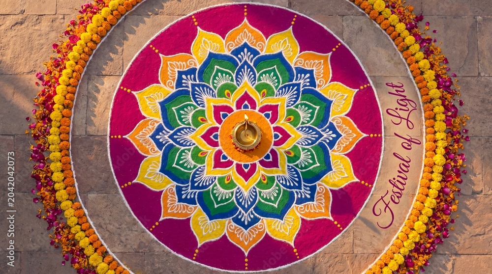 Fototapeta premium Beautiful colorful rangoli design with a lit diya lamp in the center for diwali festival celebration